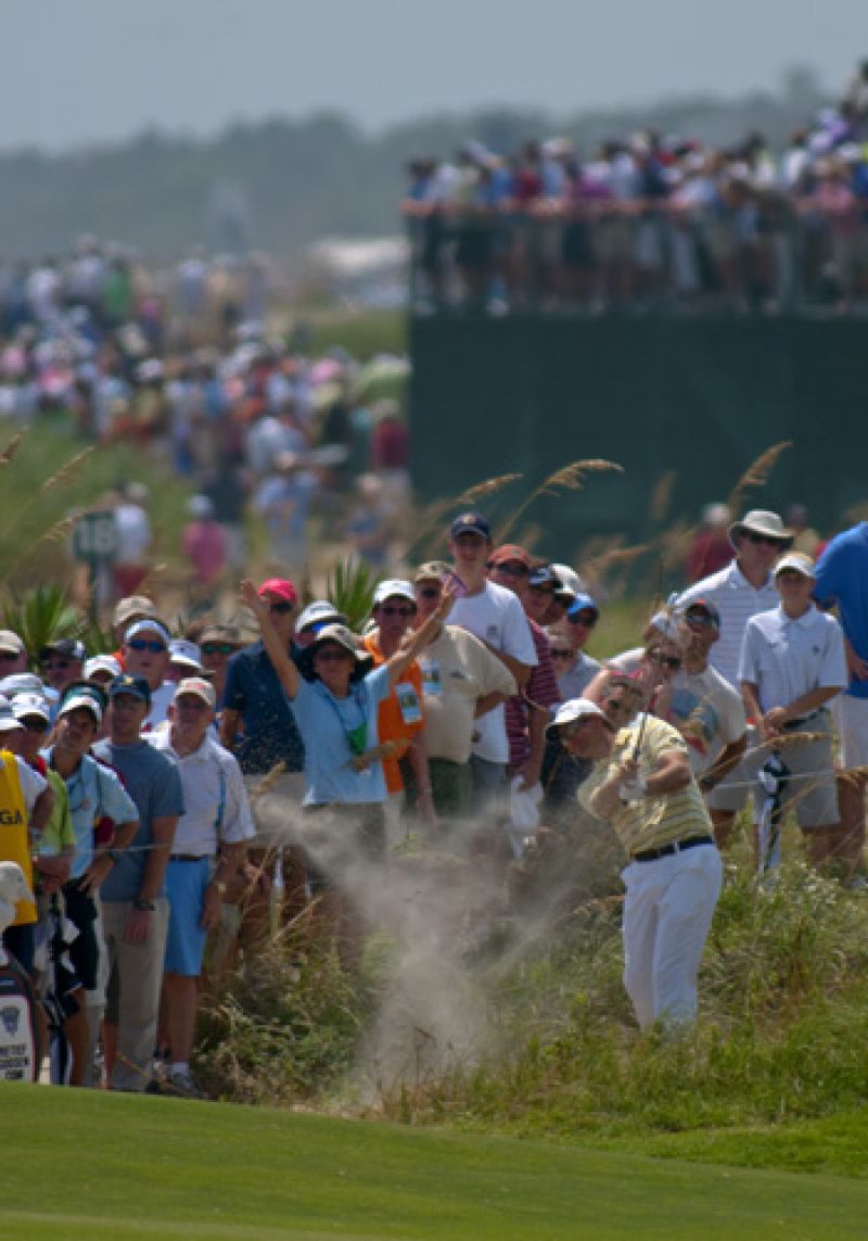 Retief Goosen hitting out of the dune brush on the 18th.