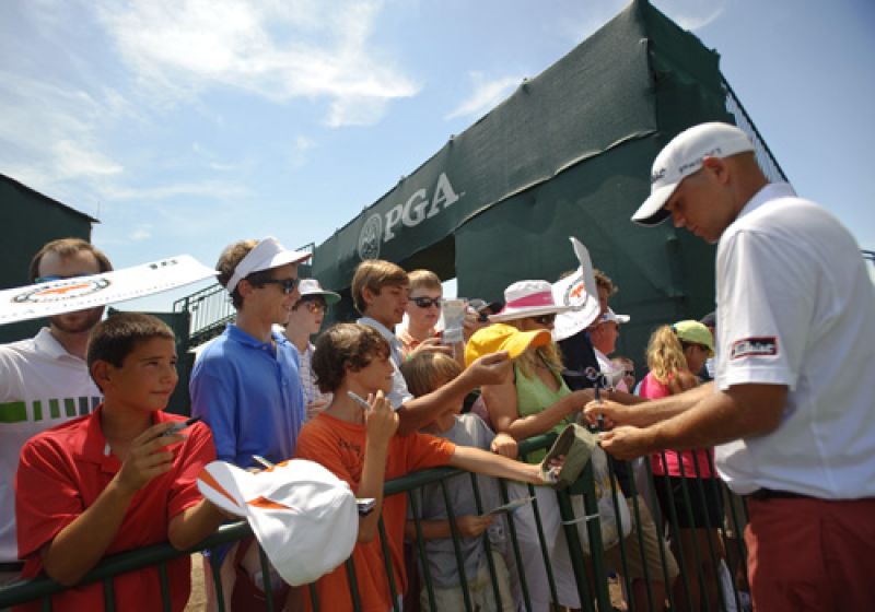 Carolina boy, Bill Haas signs autographs after finshing on 18.