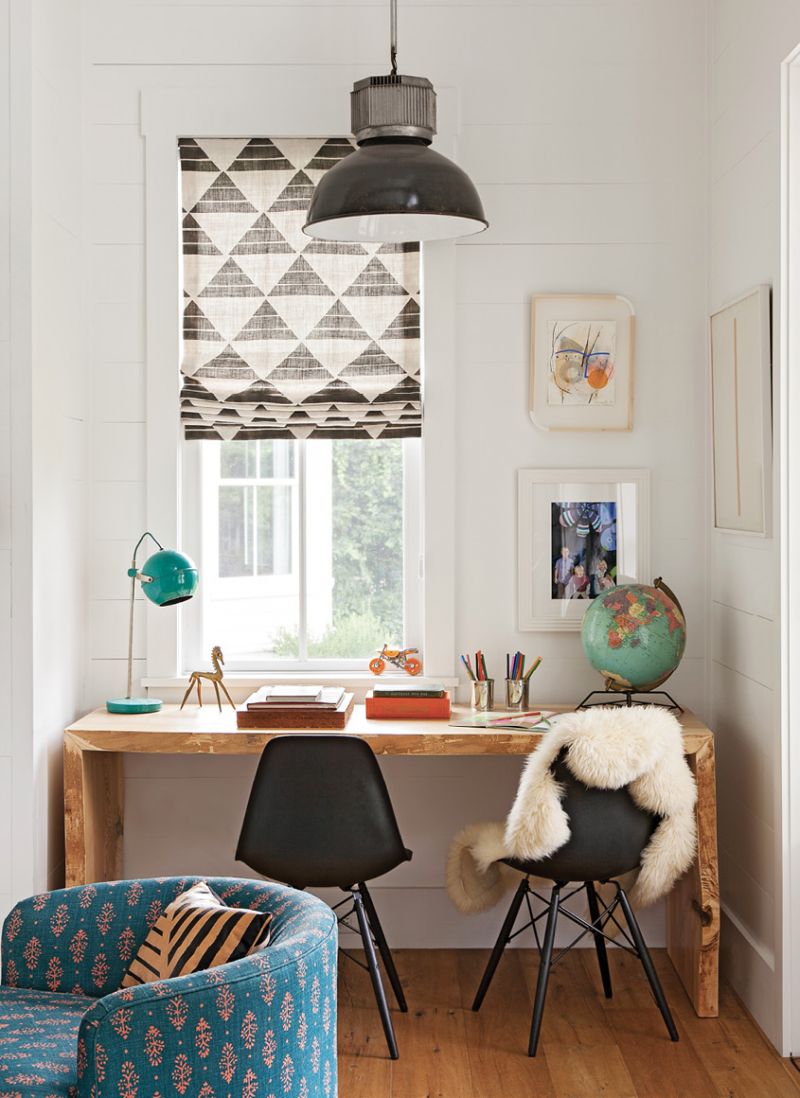 A small nook in the far corner holds a Hostetler Custom Cabinetry crafted desk and two Design Within Reach chairs for schoolwork, illuminated by a South of Market pendant light