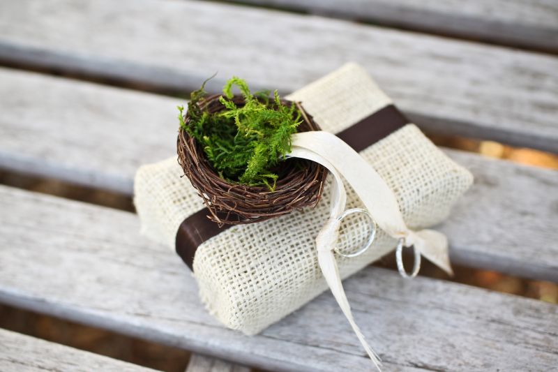 A SAFE BET: The wedding bands, delivered to the altar in a mini moss-filled nest, were secured in place by ivory ribbon.