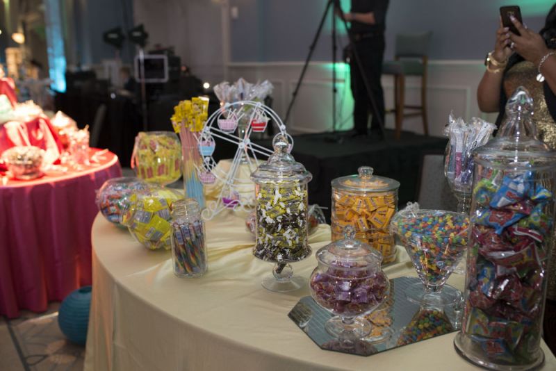 Jars of candy lined two tables letting guests have access to sweet treats throughout the night.