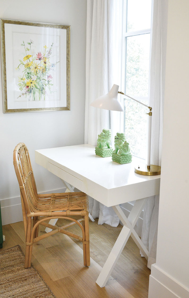 A small desk from World Market is watched over by a darling Georgia Dearborn wildflower painting and green ceramic Foo dogs.