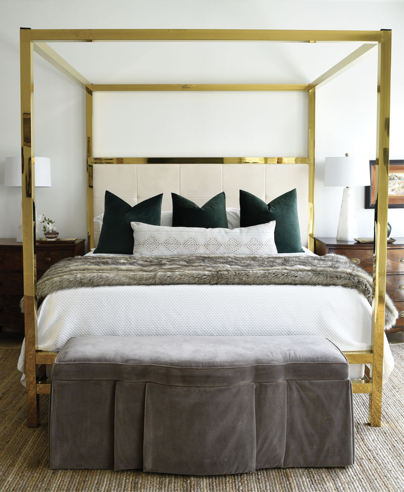 Alix’s love of brass extends to the master bedroom where this vintage four-poster bed makes a big statement. Dramatic green velvet pillows stand out against the custom sueded headboard as well as Matouk bed linens from GDC Home—all capped off by a velvet footstool from Acquisitions Interiors.