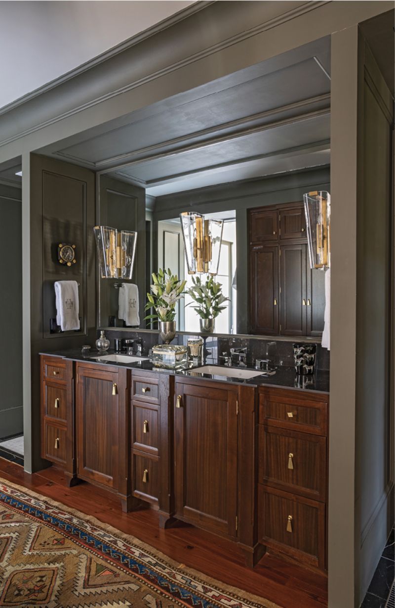 In the paneled bath and dressing room, stained-wood vanities, brass sconces, a soaking tub, and tile inlay dial it up a notch. Perhaps the most sumptuous touch? A hidden beverage station where he prepares his nightly cup of tea and morning coffee.