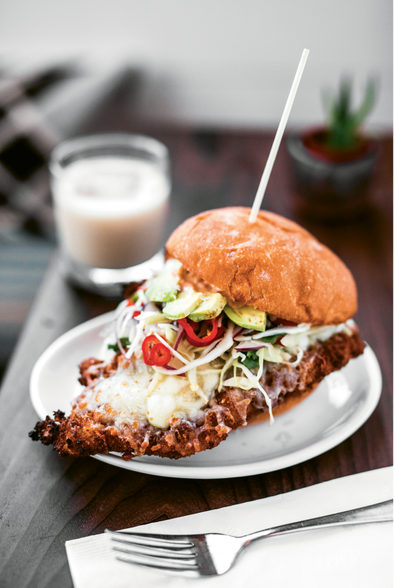 Fried pork is paired with avocado and crunchy veggies on a torta.