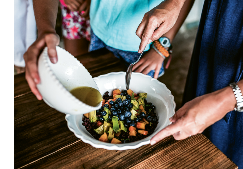 A salad of chilled black rice, mango, peaches, blueberries, avocado, and honey vinaigrette is a refreshing dish for the end of summer.