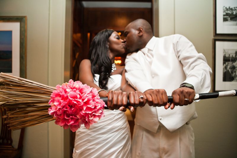 SWEPT AWAY: The broom, adorned with a bright floral bundle and satin ribbon, synced with the wedding’s palette.