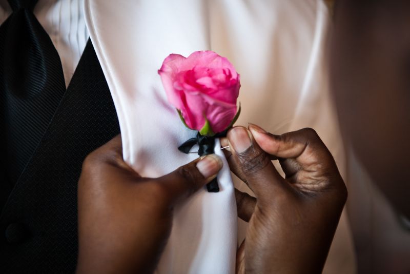 POP OF COLOR: Because the reception’s dominant colors were white, black, and pink, the bride and groom’s seats stood out with these tropical-hued bunches that were gifted to the couple by Tiger Lily Florist.