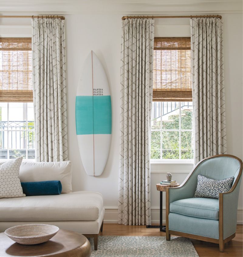 The voluminous drapes, also in Villa Nova fabric, bring warmth and texture to the walls, where a PANDA surfboard nods to Hugh’s passion for the sport.