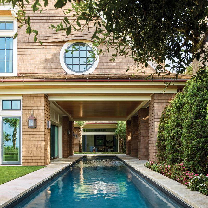 The room opens to the long, covered lap pool that connects the space to the main home.