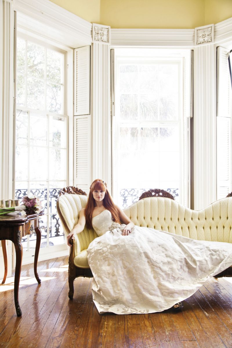 SWEET REPOSE: “Regan” ball gown in silver silk brocade and the “Pansy” belt, both from Modern Trousseau. Feather and rhinestone hair clip from Out of Hand. 14K white gold ring with smoky quartz center stone and white and chocolate accent diamonds from Skatell’s. Badgley Mischka’s “Stella” peep-toe heels  from Gwynn’s. Amaryllis bouquet by WildFlowers, Inc.