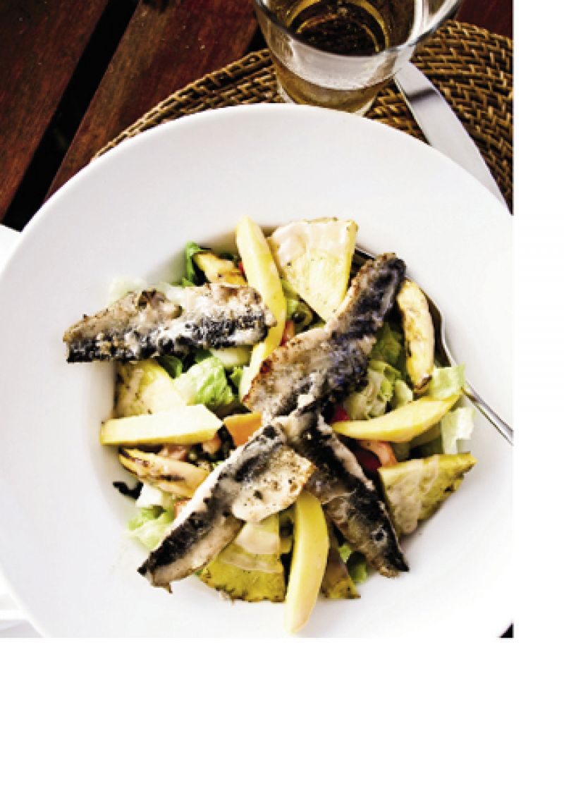 A salad version of the national dish, flying fish and cou cou, is served beachside.