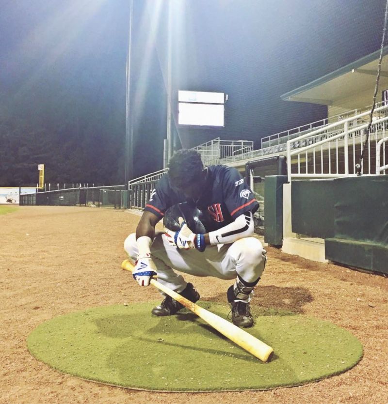 Chris at the Lexington County Baseball Stadium, bowing in prayer before a game on the one-year anniversary of the Emanuel shooting.