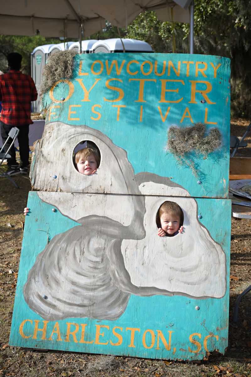 A pair of little oyster lovers pose in front of a standee in the children’s area
