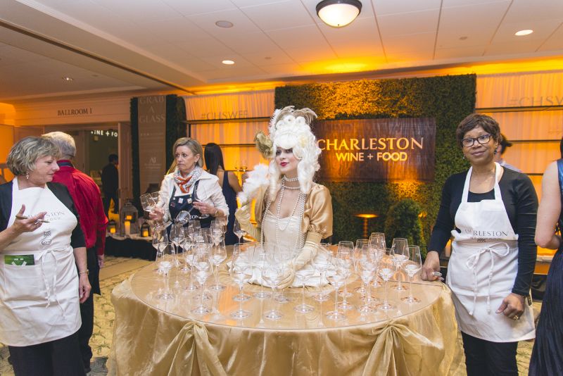 Svetlana Pavlova offers wine glasses to guests as they arrive.
