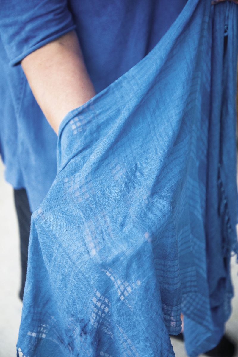 Knowing that the fabric will dry two to three shades lighter, she continues the process until the color is to her liking.