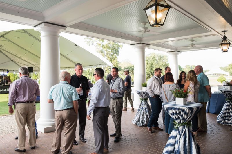 Guests mingle on the patio as the event gets started.