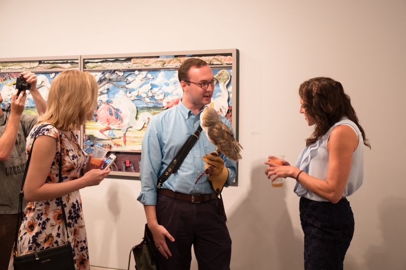 Marie Delcioppo inquires about the owl, handled by Daniel Prohaska of The Center for Birds of Prey.