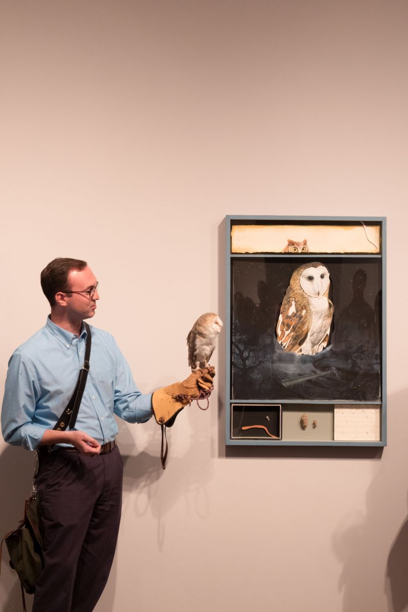 Daniel Prohaska of the Center for Birds of Prey shows off the owl next to its likeness.