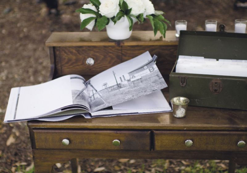 SAY HELLO: The signing book sat atop a walnut-stained antique desk that harkened the dark wood appointments throughout the reception.