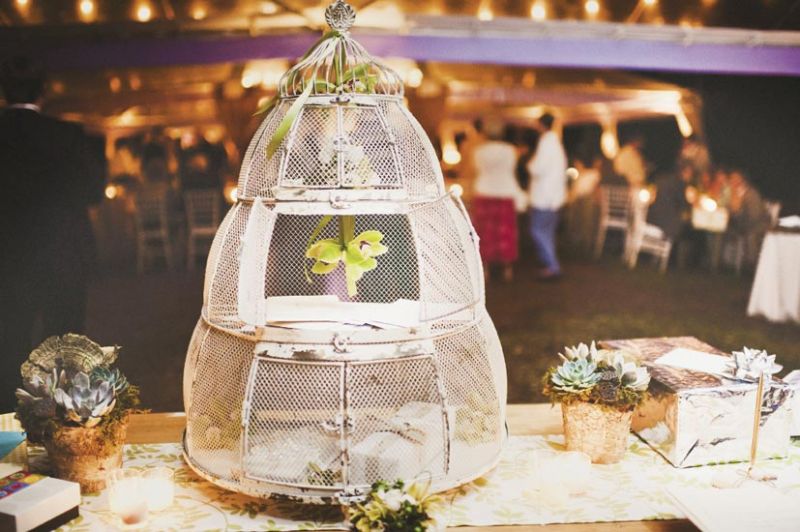 CAGED BEAUTY: A hive-shaped birdcage held cards and small presents on the gift table.