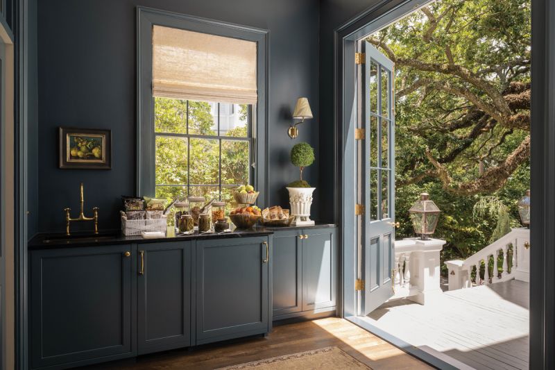 A butler’s pantry stocked with self-serve snacks and beverages connects the kitchen to the first floor’s wraparound porch, which was added to the property in 1930.