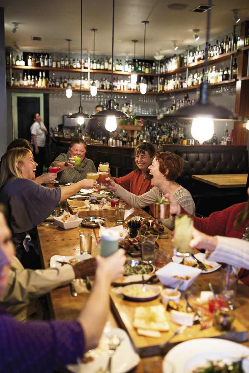 Seated around the community table, the ladies shared food, stories, and a few laughs, plus a congratulatory toast to Lauren Mitterer (opposite far right) who’s engaged to be married this March. (Opposite) the luncheon finished with small bites of decadent desserts—pumpkin cheesecake and peanut butter bar bites topped with Pop Rocks and sea salt. For recipes visit charlestonmag.com/LeadingLadies.