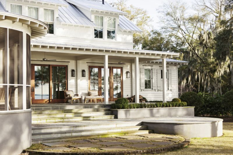 A wraparound back porch and large-pane glass doors bring the outside in.