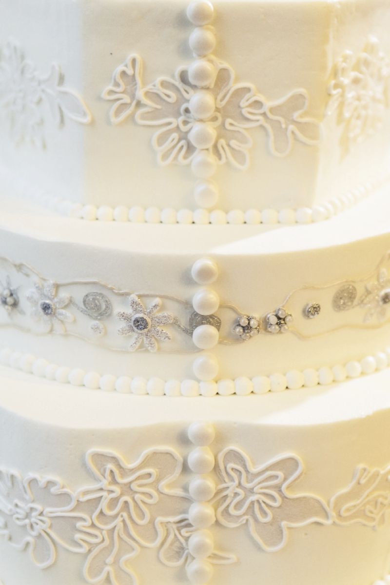 BUTTONED UP: Buttons mimicking those of the gown ran down five tiers of the confection