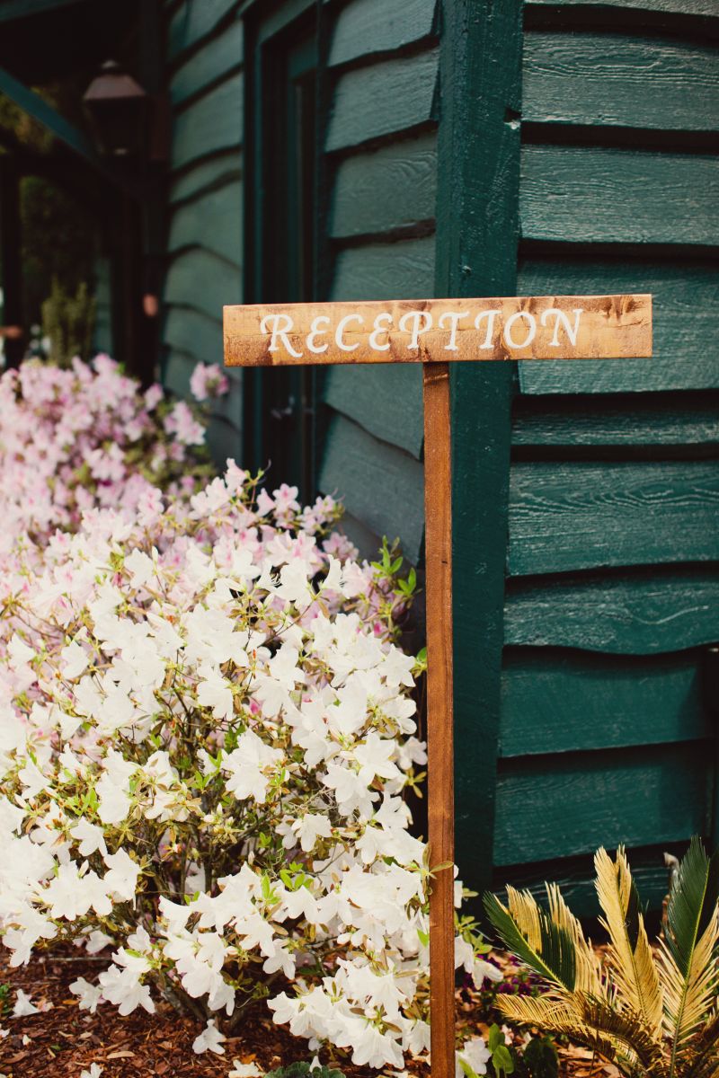 HANDYMAN HELP: In addition to staining the wooden “Ceremony” and “Reception” signs, Jared pitched in by building corn hole boards and planning the rehearsal dinner. Says Ashton, “He was a huge help!”