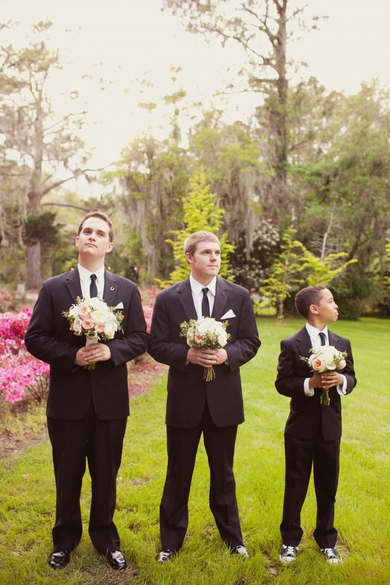 SUIT UP: The groom and his companions wore Men’s Wearhouse. Junior groomsman Gavin added age-appropriate flair to his get-up with black-and-white Converse.