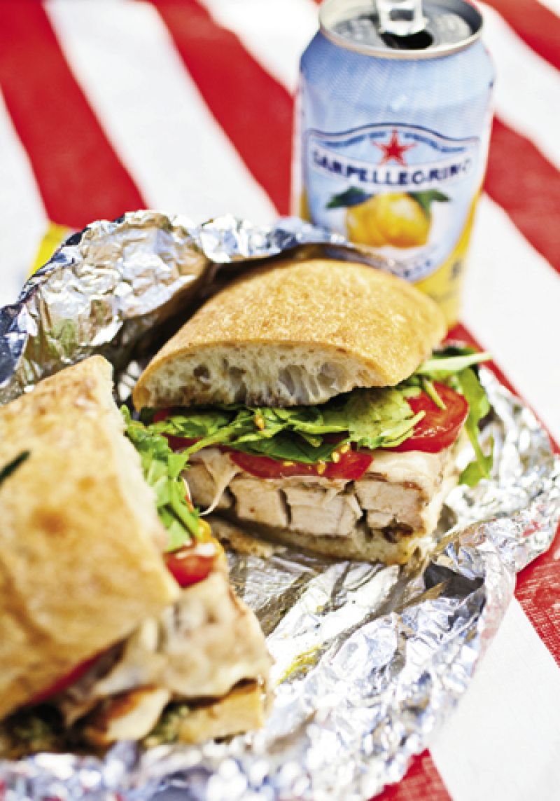 a savory chicken cutlet sandwich complete with Sanpelligrino Aranciata Italian soda