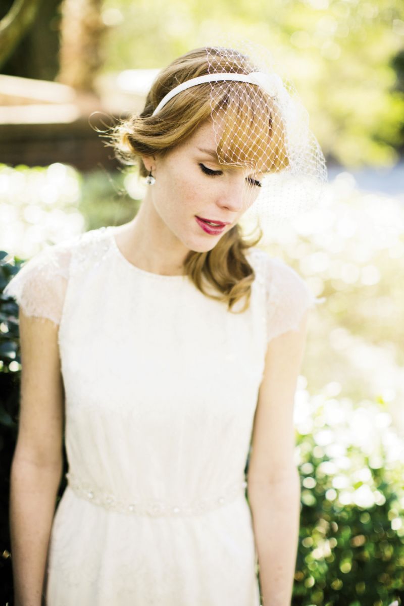 IDLE THOUGHTS: Jenny Packham’s “Petal” silk charmeuse and Chantilly lace dress with rhinestones, seed pearls, and  sequins from  White on Daniel Island. B. Veil’s birdcage head-band veil from Jean’s Bridal.  A &amp; Furst’s blue topaz earrings  from Paulo  Geiss Jewelers.