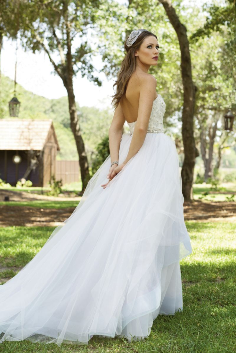 Lazaro’s “Wisteria” gown with crystal embellished and embroidered bodice and mint and lavender colored layered tulle skirt from Jean’s Bridal. Silver-plated bracelet with cubic zirconia stones from filigree. Ophelie Hats’ gray silk  rosette headband from Out of Hand.