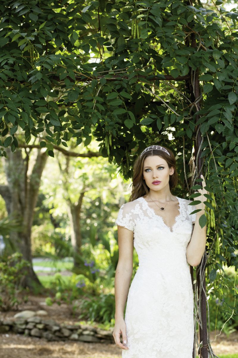 Jim Hjelm’s lace V-neck gown with cap sleeves from Bridal House of Charleston and Gown Boutique of Charleston. Crystal embellished headband from Jean’s Bridal. 14K yellow gold necklace with 12 ct. smoky quartz center stone accented with white and chocolate diamonds from Joint Venture Estate Jewelers.