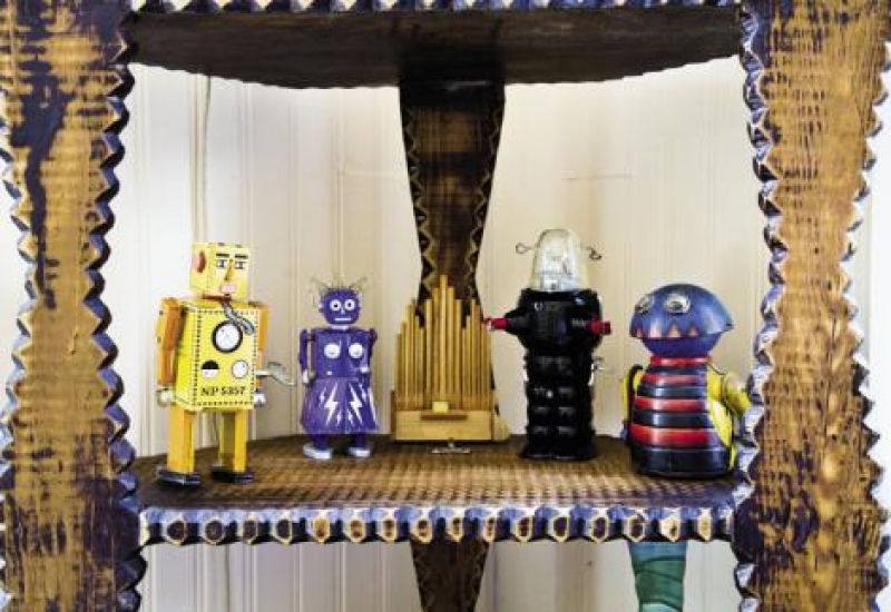 at your service: A varied display of tiny robot figurines stands guard in the sunroom.
