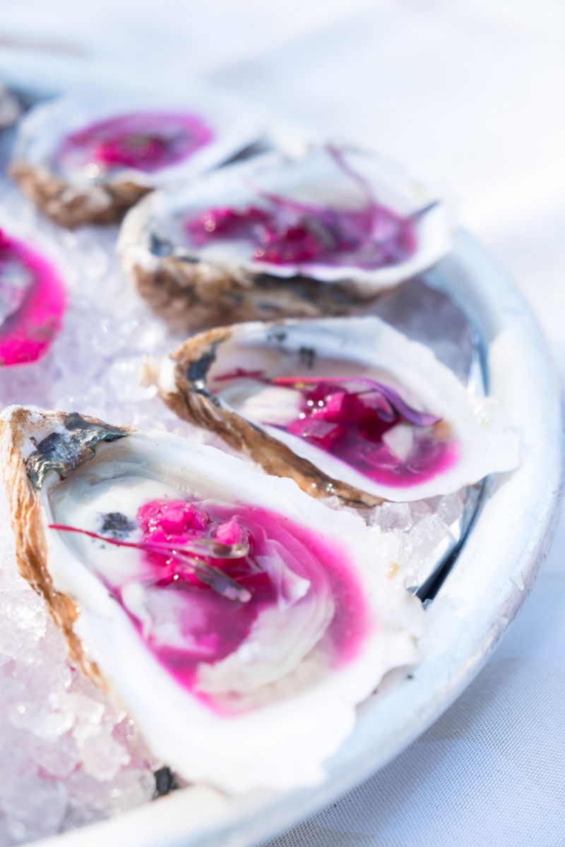 Turning bright fuschia from a topping of muscadine vinegar, diced daikon radish, and beets, The Obstinate Daughter&#039;s oysters were certainly eye-popping