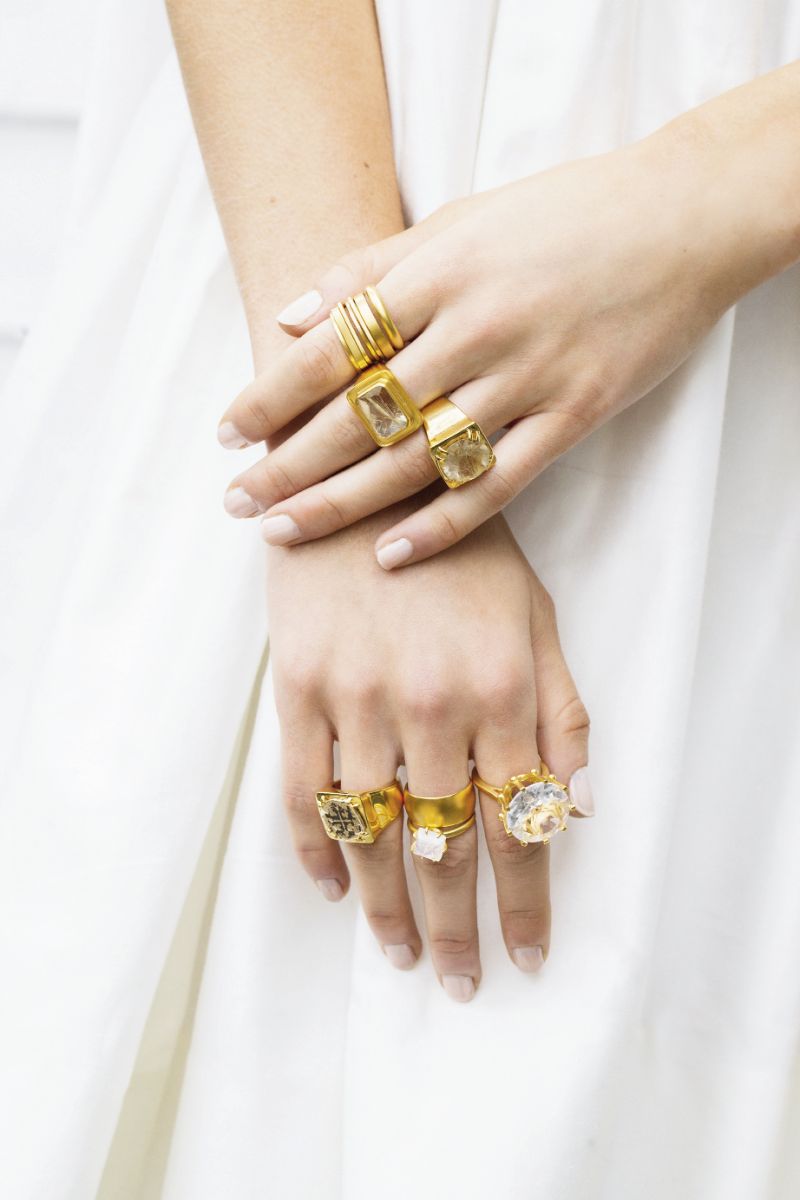 Stackable gold rings, $25-$35 each; “Enamel” 18K gold with quartz, $295; “Tortuga” 18K gold with quartz, $295; “Coin” 18K gold with antique Spanish coin, $295; “Rainbow Moonstone” 18K gold, $169; “Crown” 18K gold with quartz, $275; all by Van H., at vanhjewelry.com