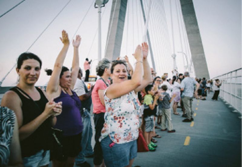 An estimated 15,000 people joined hands in a “Bridge to Peace” unity chain across the Ravenel. Though uplifting and symbolic, it was “an immediate emotional response, not real change,” says Rev. Dr. Kylon Middleton. Photograph by Floyd Smalls Jr.