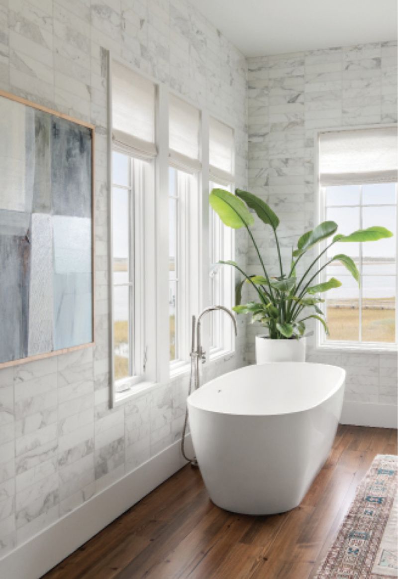 The relaxing theme continues in the primary bathroom, featuring Calacatta marble walls and a Mirabelle tub.