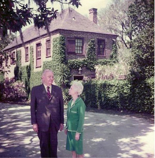 Claude W. and Helena I. Blanchard in front of the circa-1750 carriage house at Fenwick Hall.