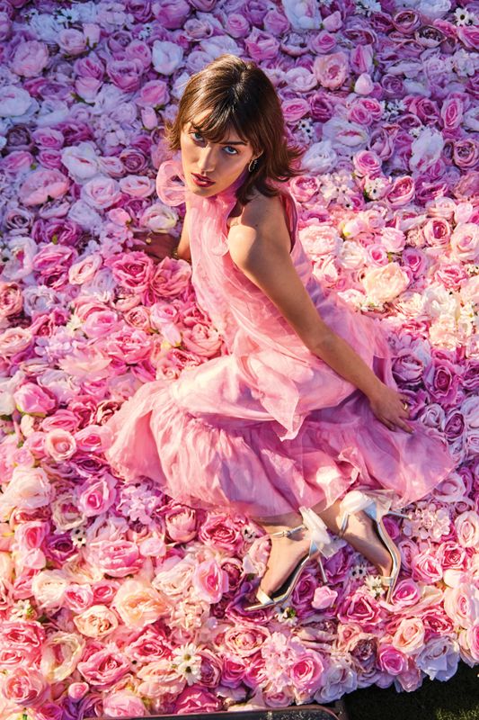 <strong>La Vie En Rose:</strong> (Opposite) Emily Westenberger the Label “Rosemary” dress in silk taffeta and organza with a custom watercolor floral print, $1,150 at <a href="https://emilywestenberger.com/" target="_blank">emilywestenberger.com</a>; Roberto Coin “Love In Verona” diamond and gold earrings, $6,400 at <a href="https://www.reeds.com/roberto-coin-love-in-verona-diamond-twisted-rope-circle-yellow-gold-earrings-plu20473542.html" target="_blank">Reeds</a>; Marco Bicego “Jaipur” bracelet, $13,740 at <a href="https://www.demetrejewelers.com/" target="_blank">MP Demetre Jewelers</a>; Julie Vos rings, $110 and $125, and Dean Davidson ring, $250, at <a href="https://www.shopwellfurnished.com/" target="_blank">Well Furnished</a>; Deltan “Abbie Bow” sandals, $66 at <a href="https://www.dillards.com/p/deltan-abbie-bow-dress-sandals/519061835" target="_blank">Dillard’s</a>  - (Prop) Flower wall from <a href="https://www.weddingflowersforrent.com/" target="_blank">Wedding Flowers for Rent</a>