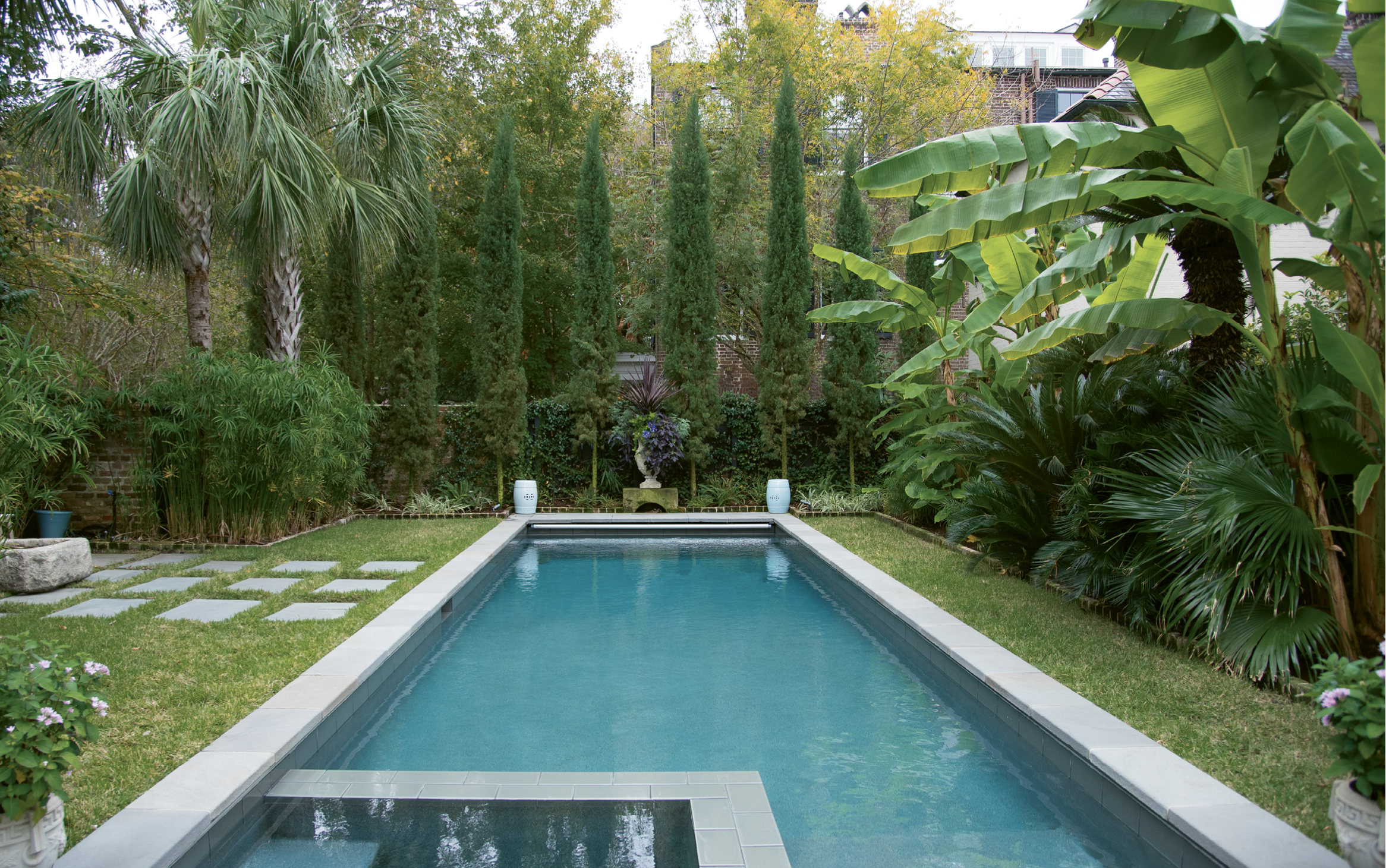 Calm &amp; Cool: The garden’s final room conjures the Mediterranean with an all-green landscape that mingles Italian cypress trees, Confederate jasmine, variegated flax lily, sago palms, and banana trees.